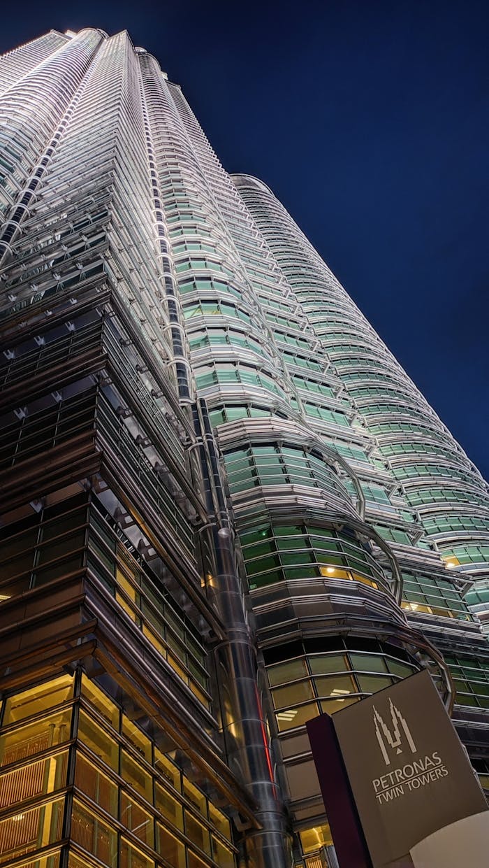 Stunning view of the Petronas Twin Towers illuminated at night in Kuala Lumpur, Malaysia.