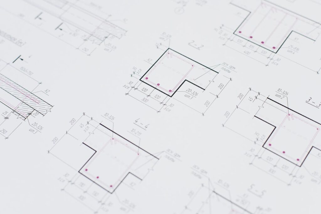 High-resolution close-up of detailed architectural blueprints showcasing precision design layouts.