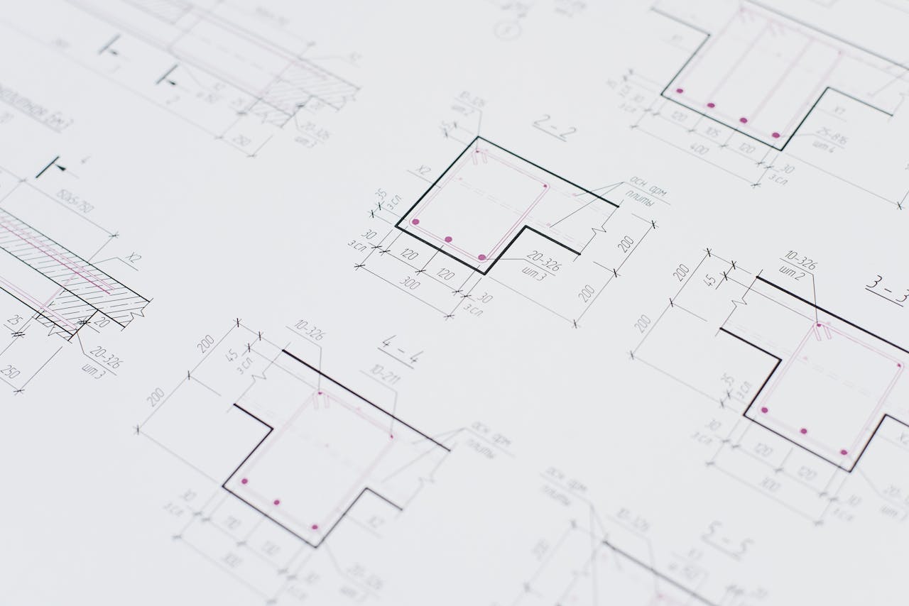 High-resolution close-up of detailed architectural blueprints showcasing precision design layouts.