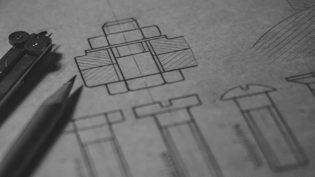 pexels-photo-716661 Detailed technical blueprint with pencil and compass illustrating engineering design concepts.